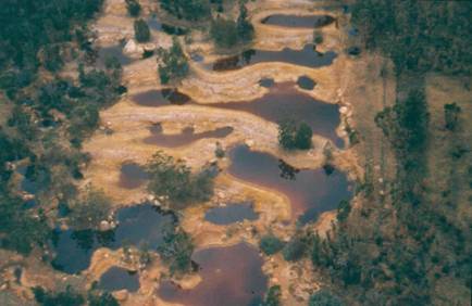 Red acidified water in a collapsed coal mine in Witbank http://chrissiesmeer.co.za/images_mining/005.jpg